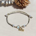 Βραχιόλι Γούρι 2026 επίχρυσο Ρόδι με Μάτι και λευκό Σμάλτο σε χρυσό Γυαλιστερό κορδόνι - Image 2